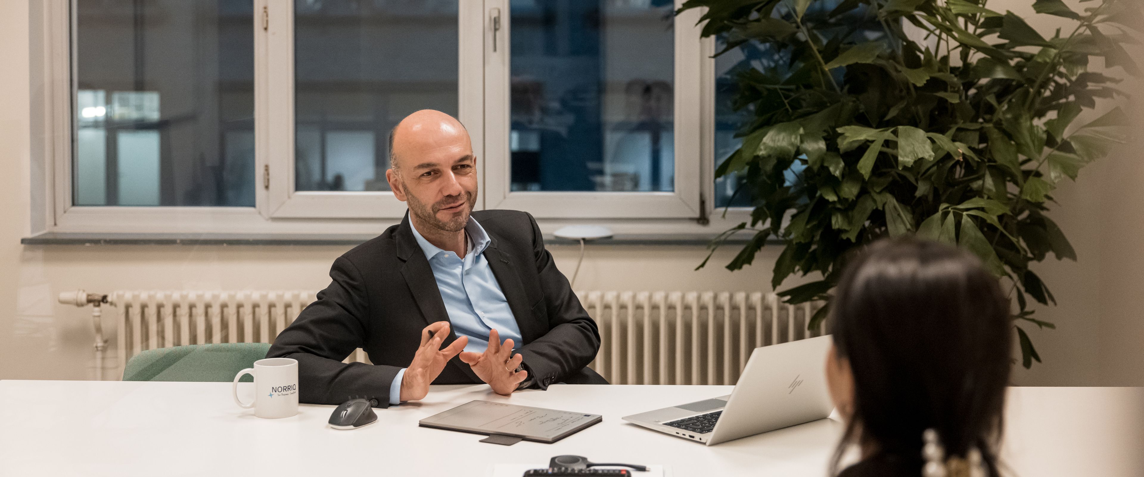 Two people having a discussion at a table in an office setting